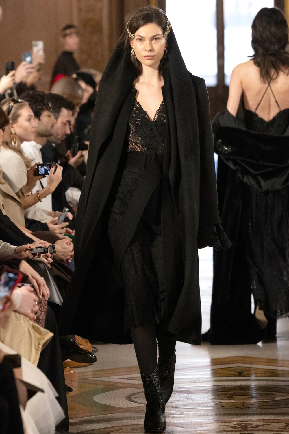 Long wool coat with detachable scarf, straight silhouette, tailored seams; front view on model, editorial setting.