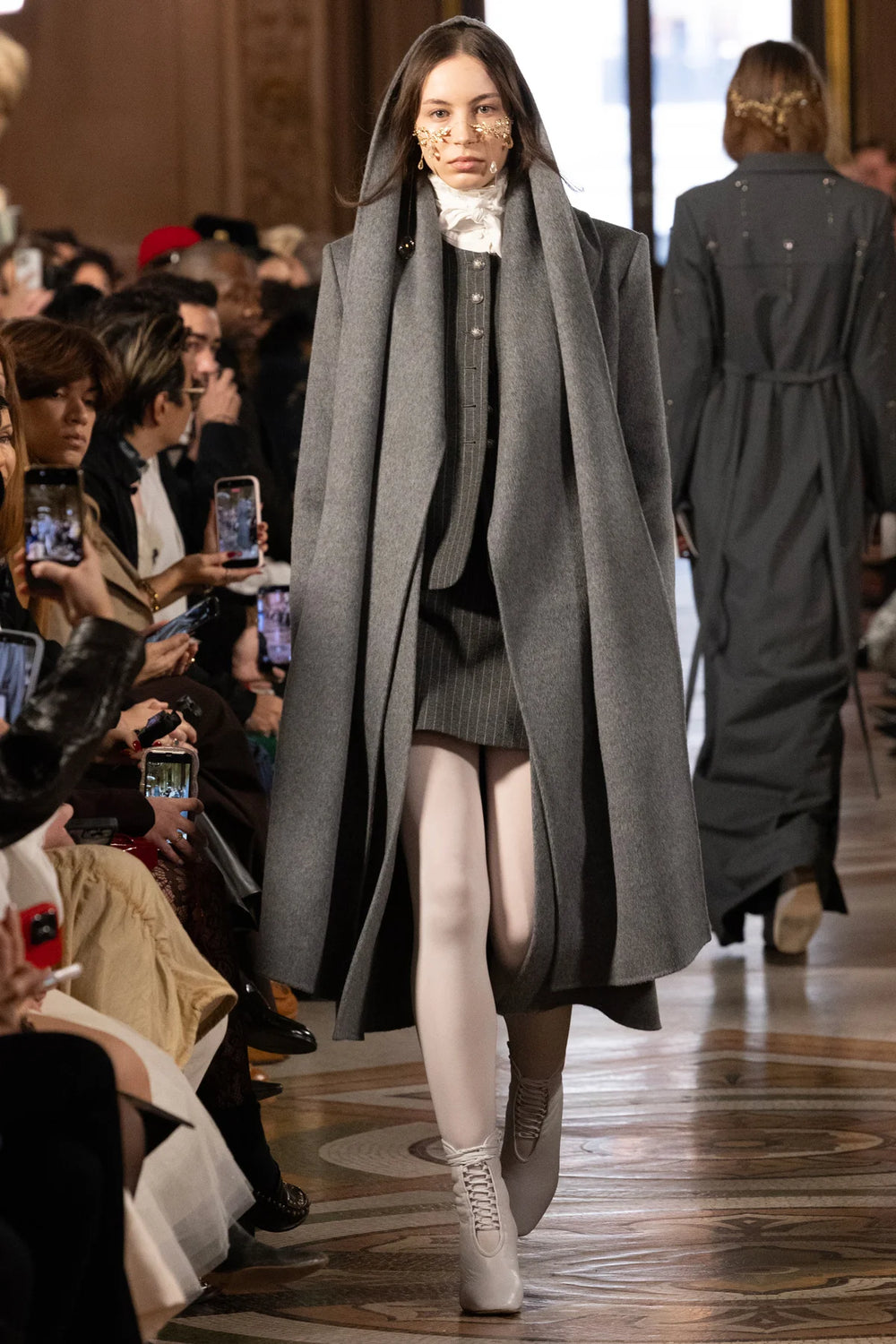 Relaxed, longline wool coat with detachable scarf, tailored seams and notched collar; front view on model.