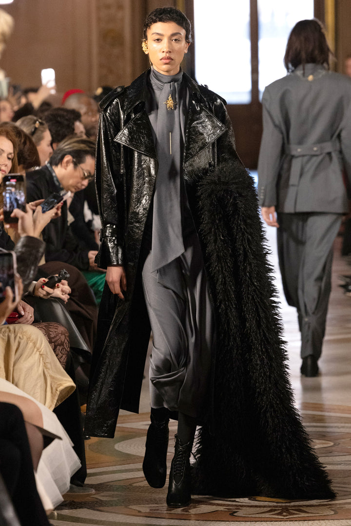 Longline vegan leather coat with structured shoulders and clean lines, front view on model.