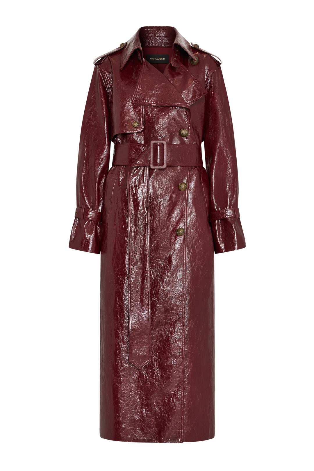Glossy vegan trench coat with wide lapels, military hardware, buttons, and belt. Front view on white.