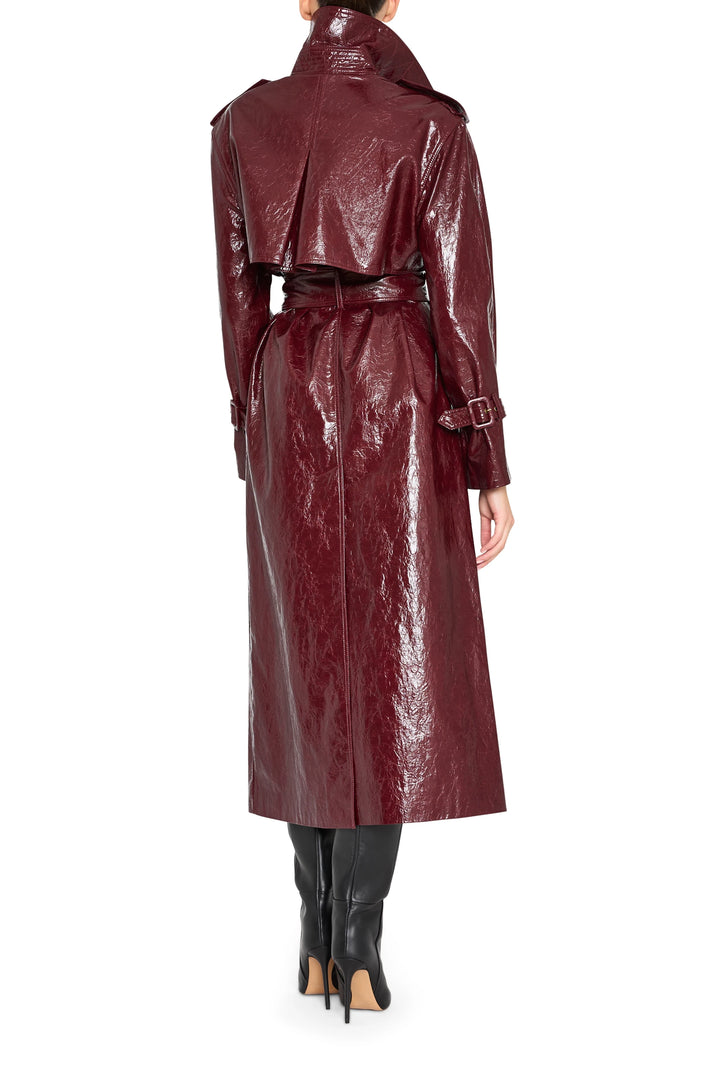 Longline vegan leather coat with structured silhouette, military hardware, and tailored seaming; back view on model.