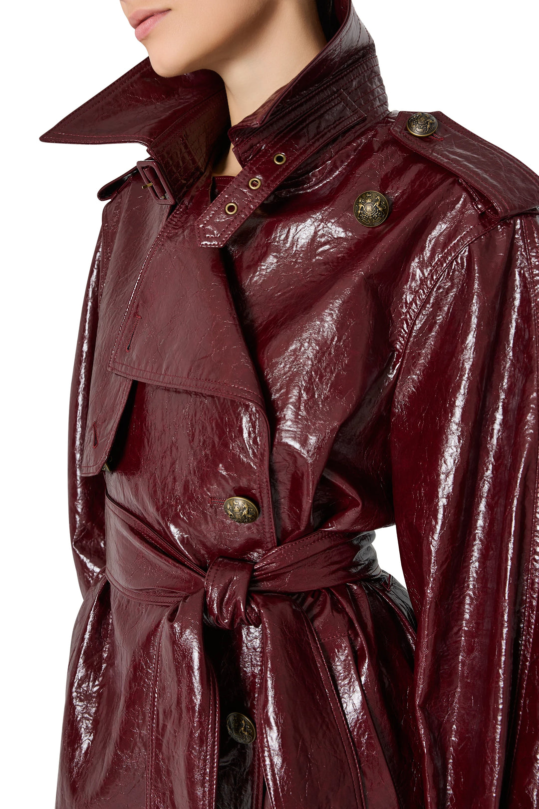 Shiny vegan leather coat with large buttons, waist tie belt, and half-up collar; front view on model.