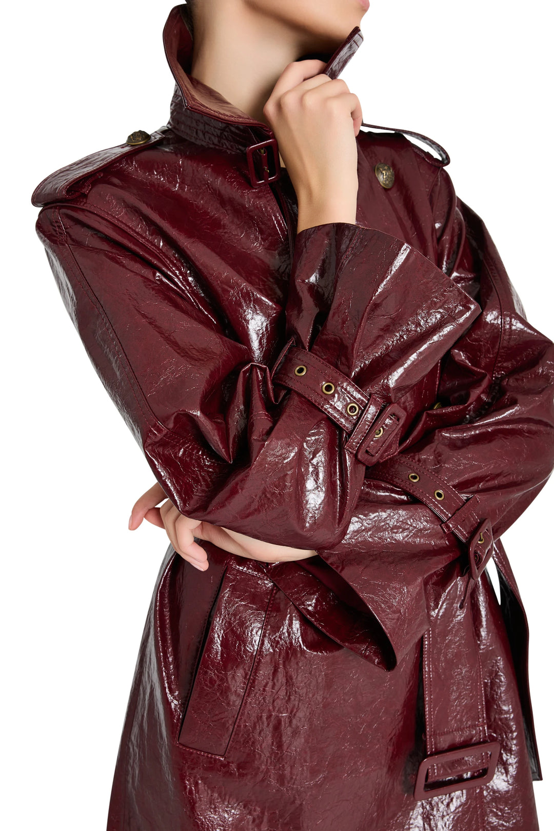 Longline vegan leather coat with structured shoulders and notched lapel. Front view on model.