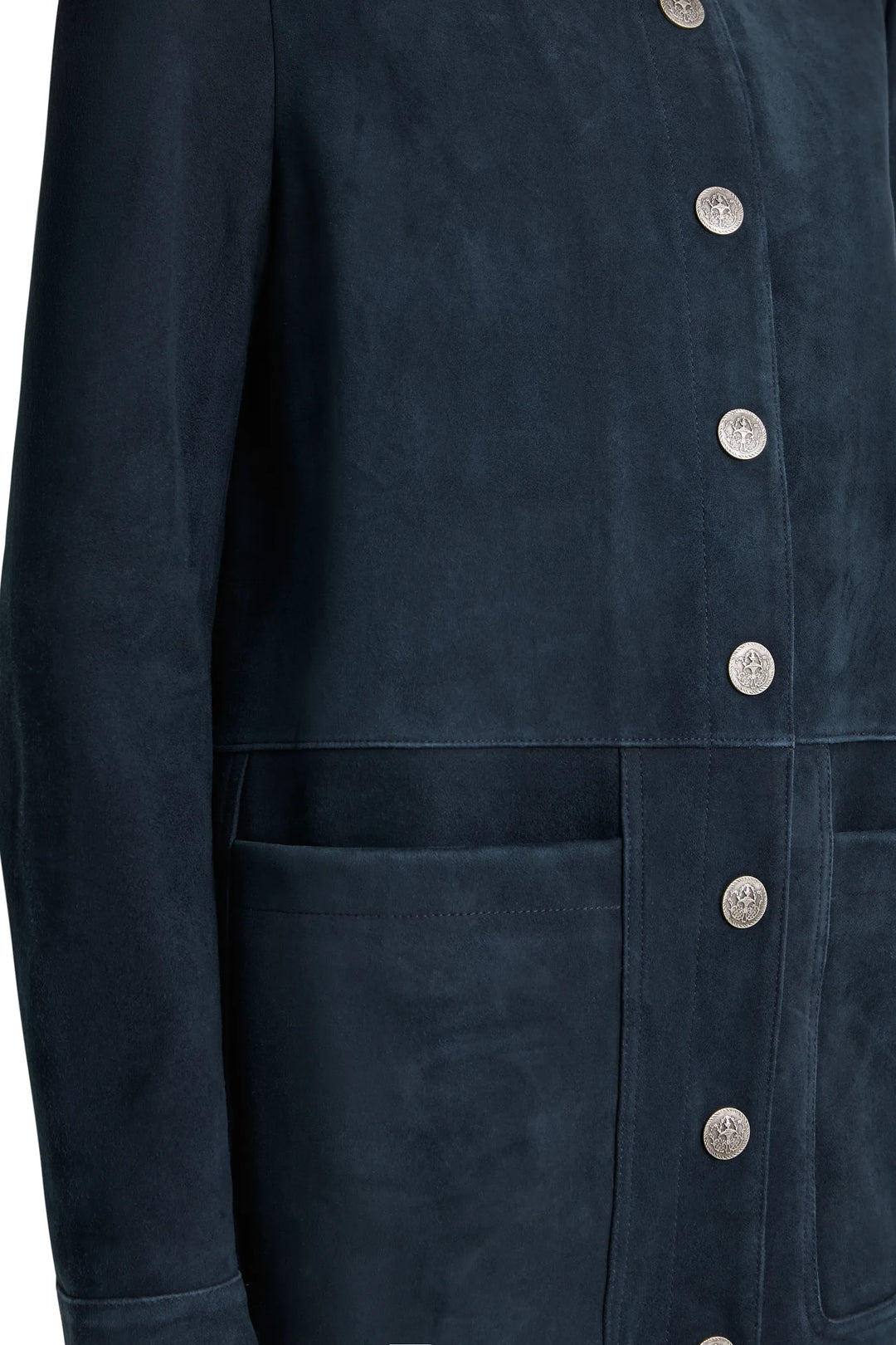Artisan snap detail on suede; visible topstitching and large front pocket seam. Detail view.