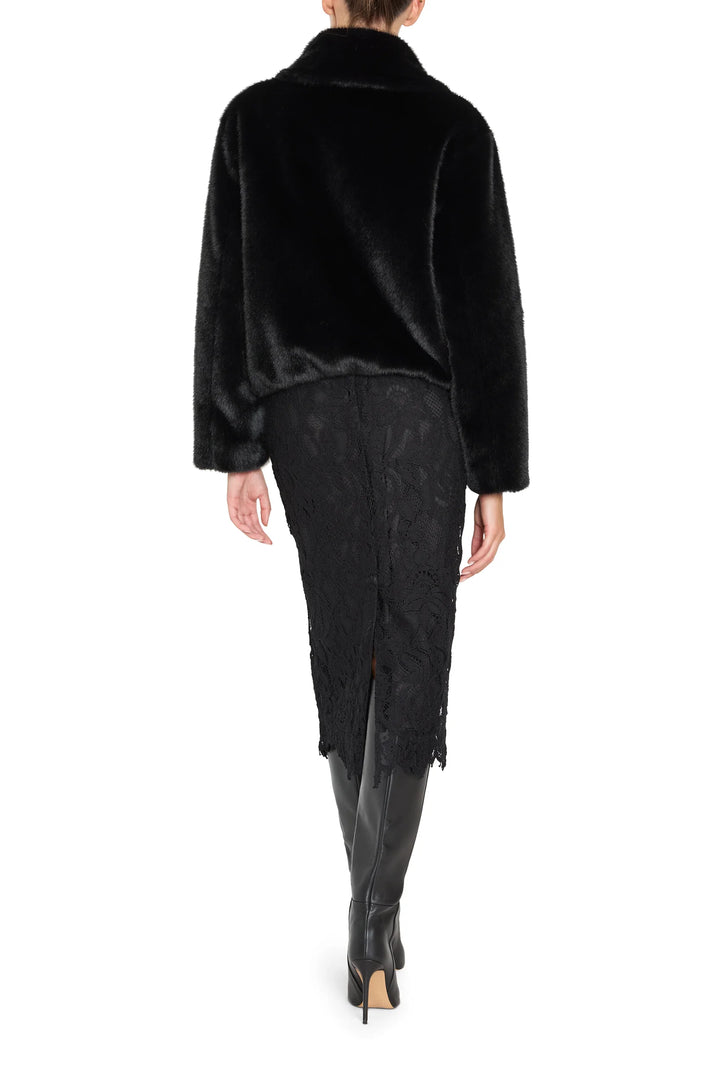 Short faux fur coat with jeweled accents, structured silhouette, plush texture; back view on model.