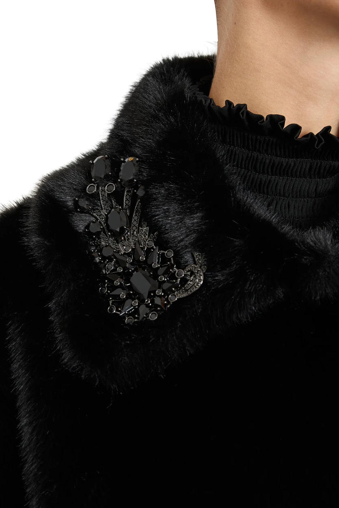 Boxy faux fur short coat with jeweled embellishments, collar, and concealed closure; front view on white.