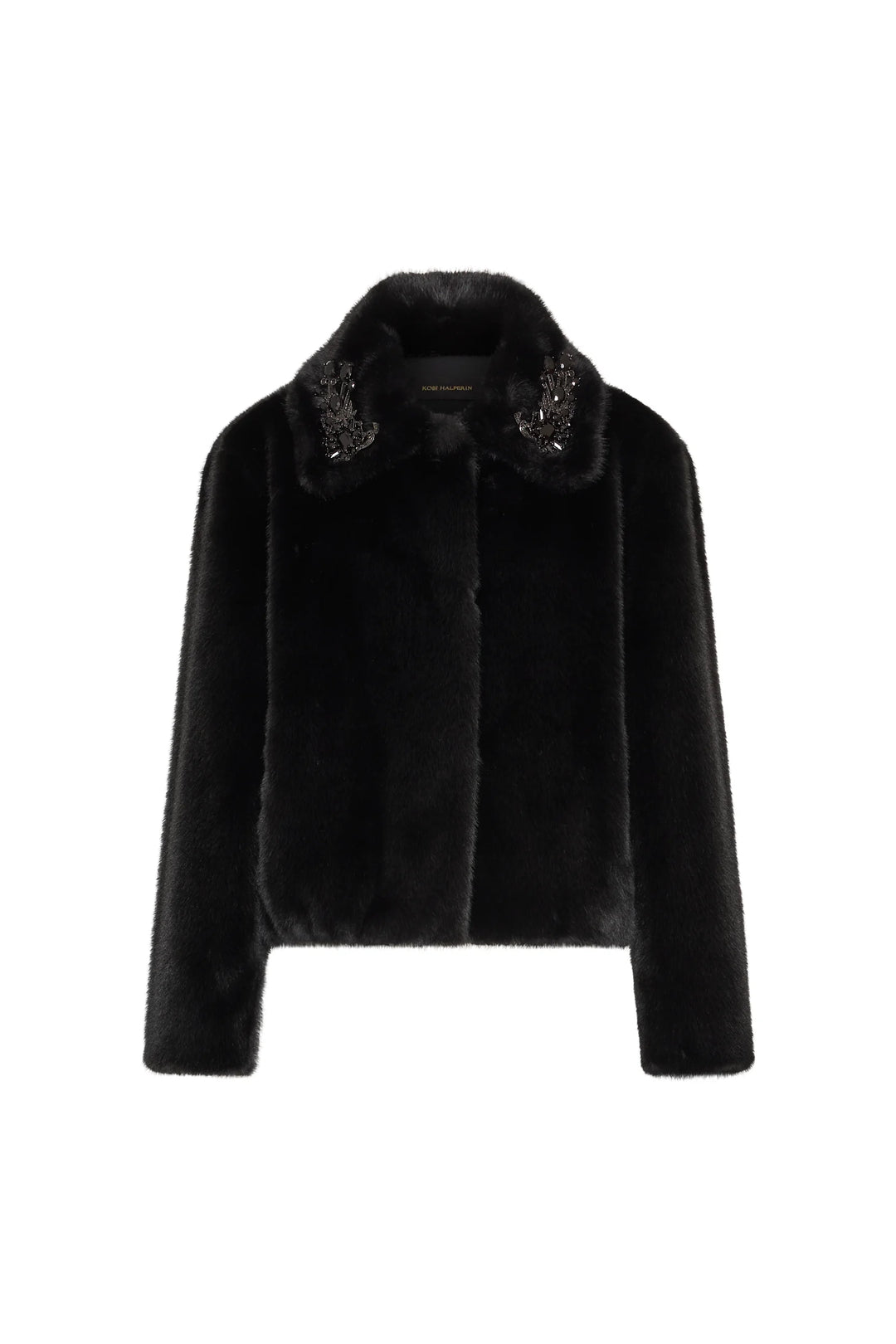 Cropped faux fur jacket with retro silhouette, jeweled brooches on collar, structured fit; front view on white.
