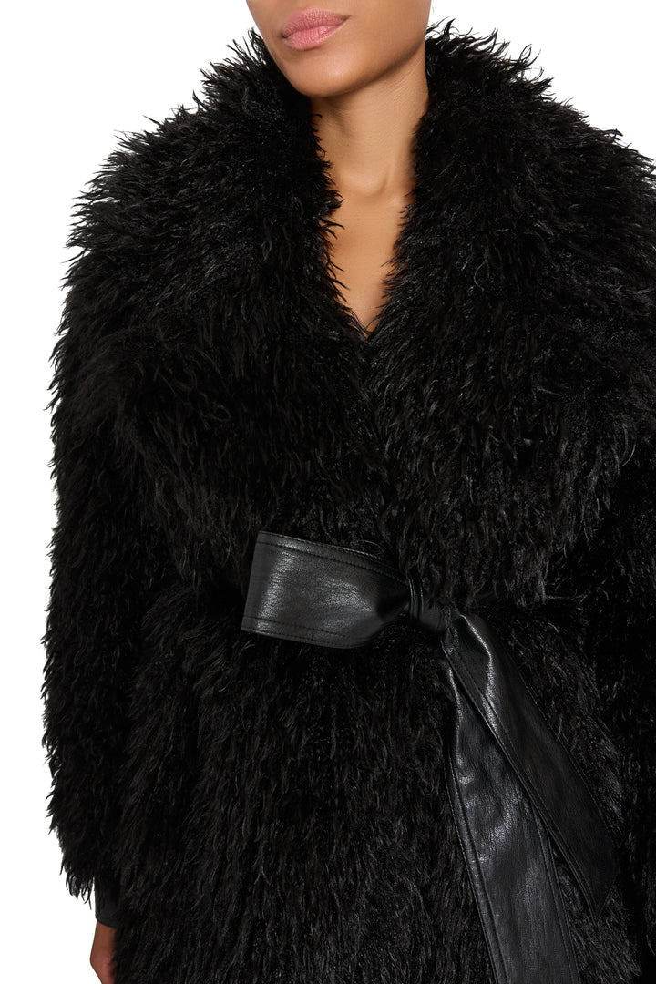 Faux Mongolian coat with plush textured fabric, wide vegan leather belt, relaxed silhouette; front view on model.
