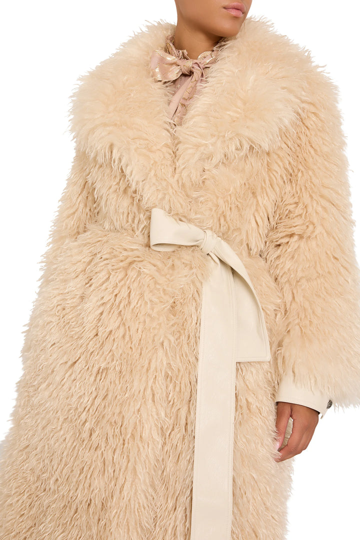Faux Mongolian coat with large collar, belted waist, plush textured fabric; front view on model.