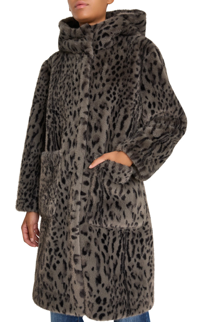 Knee-length faux fur coat, relaxed silhouette, classic collar, front closure. Front view on model.