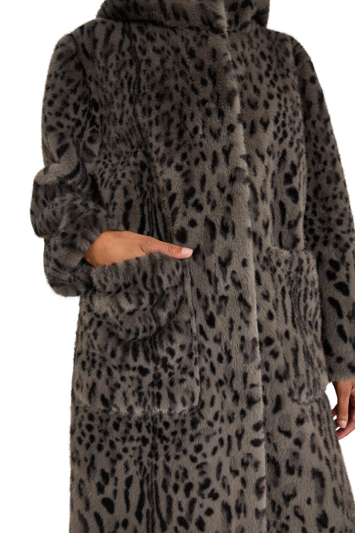 Long hooded faux fur coat with leopard spots, relaxed fit, side pockets. Front view on model.