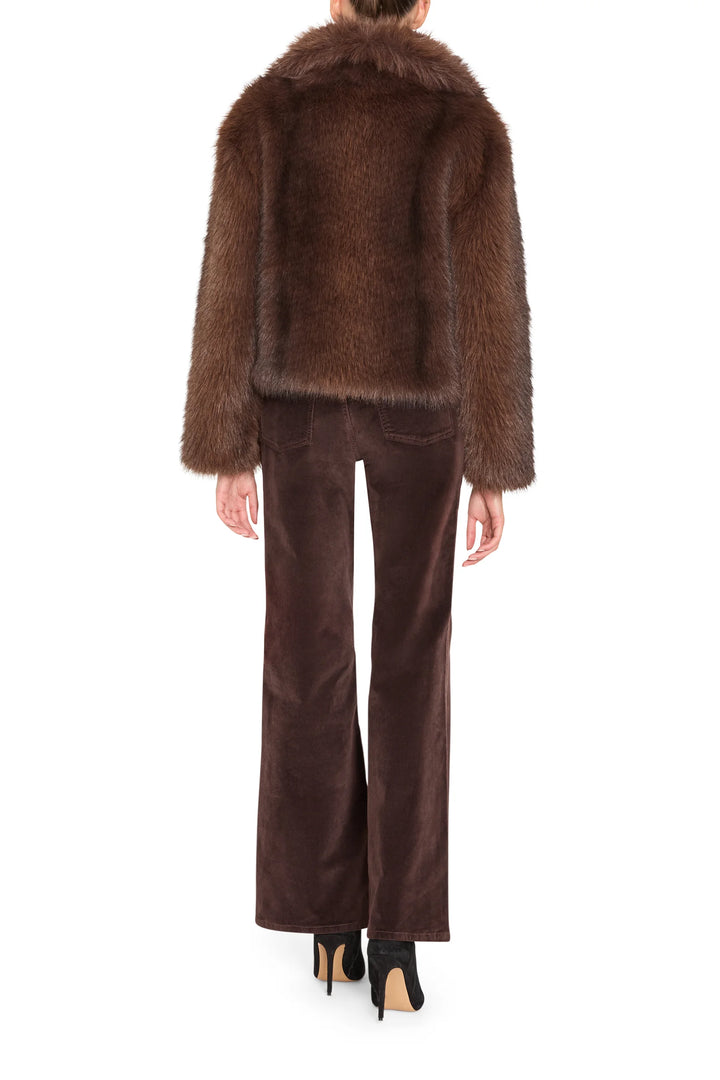 Boxy faux fur jacket with cropped hem and collar, visible seaming; back view on model.