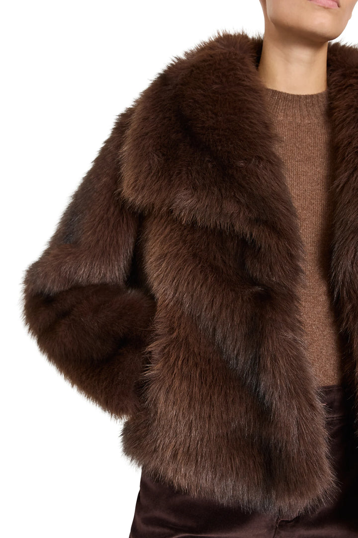 Short faux fur coat with shawl collar and cropped silhouette, tailored fit; front view on model.