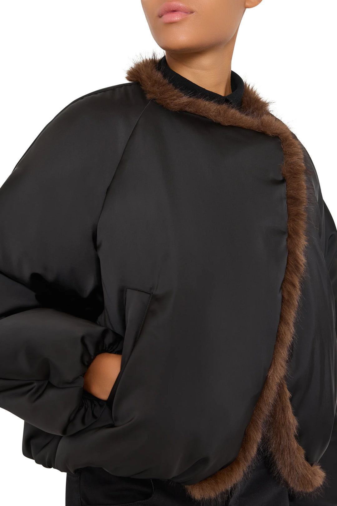 Straight-cut faux fur coat with contrast trim, hip length, hand pockets. Front view on model.
