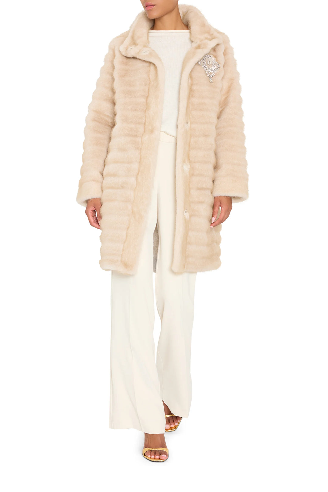 Long faux fur coat with jeweled embellishments, straight silhouette; front view on model.