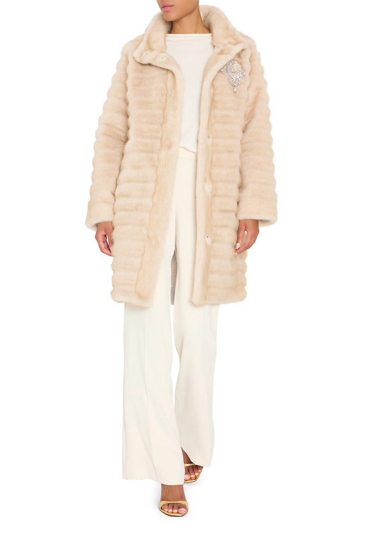 Long faux fur coat with jeweled embellishments, straight silhouette; front view on model.