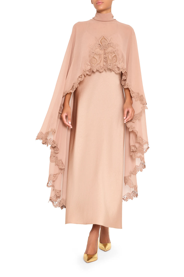 Beige Carmen long dress with attached cape, lace trim accents, fluid silhouette, front view on white.