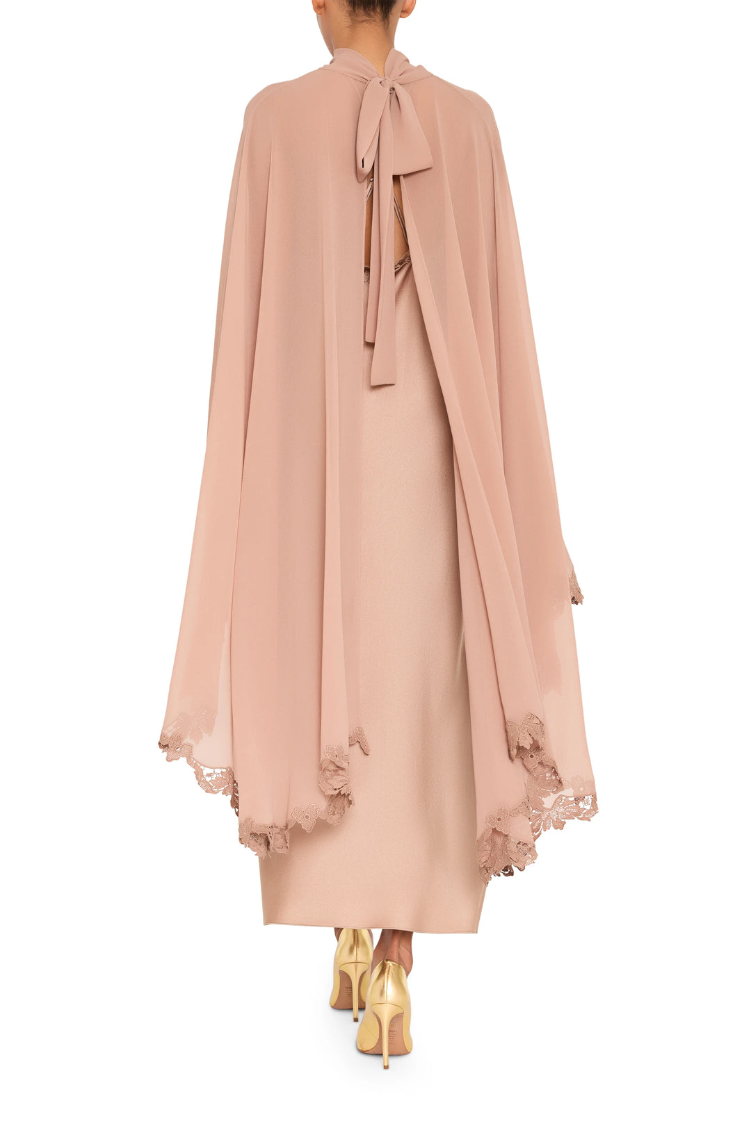 Carmen long dress with cape, lace trim, draped silhouette, flowing skirt and structured shoulders; back view on model.