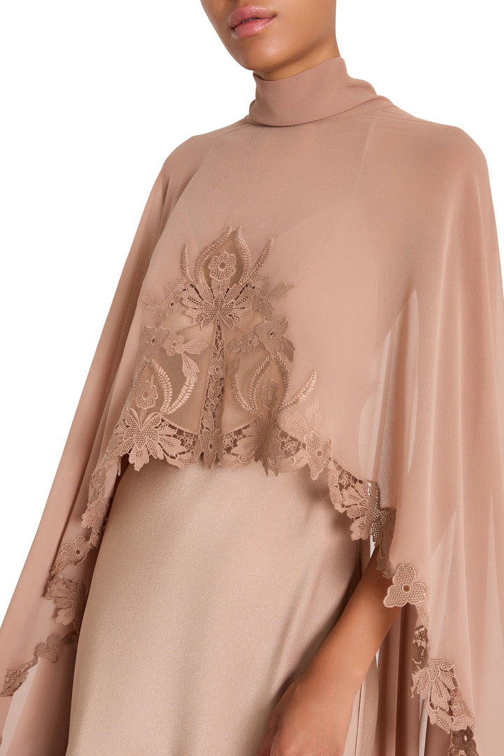 Blush-pink Carmen long dress with cape, lace accents, satin-back crepe, flowing sleeves; front view on model.
