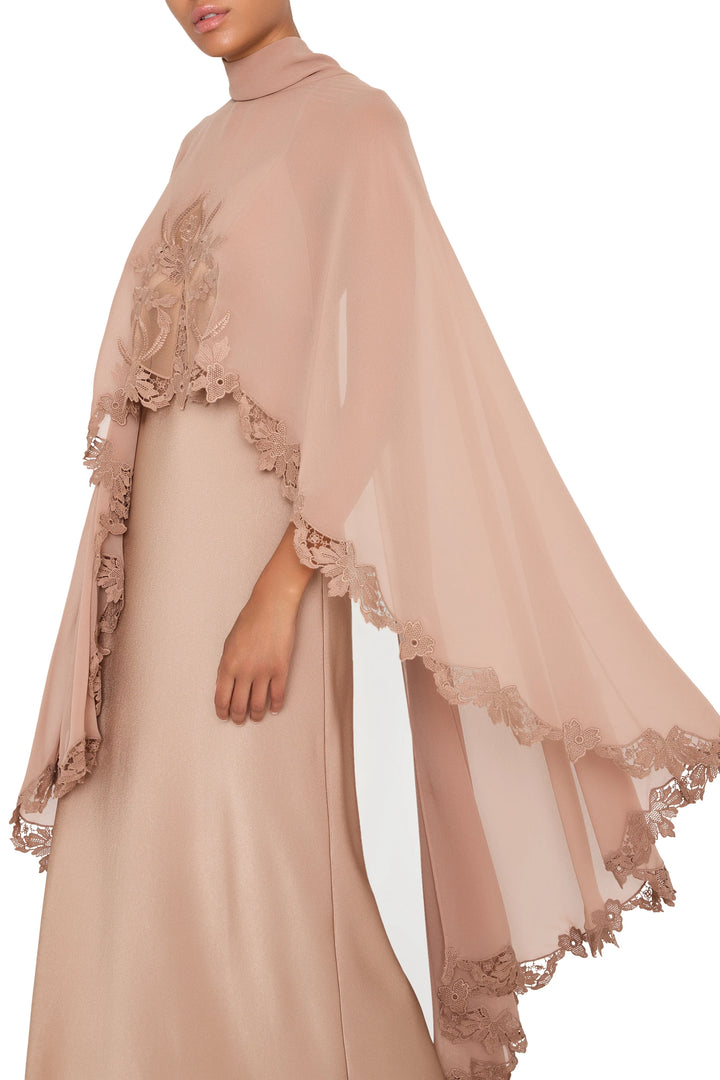Blush pink crepe Carmen long dress with attached cape, fluid silhouette, floor length; front view on model.