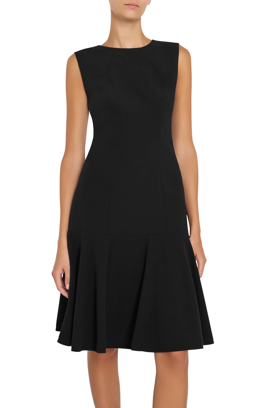 Sleeveless black crepe fit-and-flare dress with drop waist and flared skirt; front view on model.