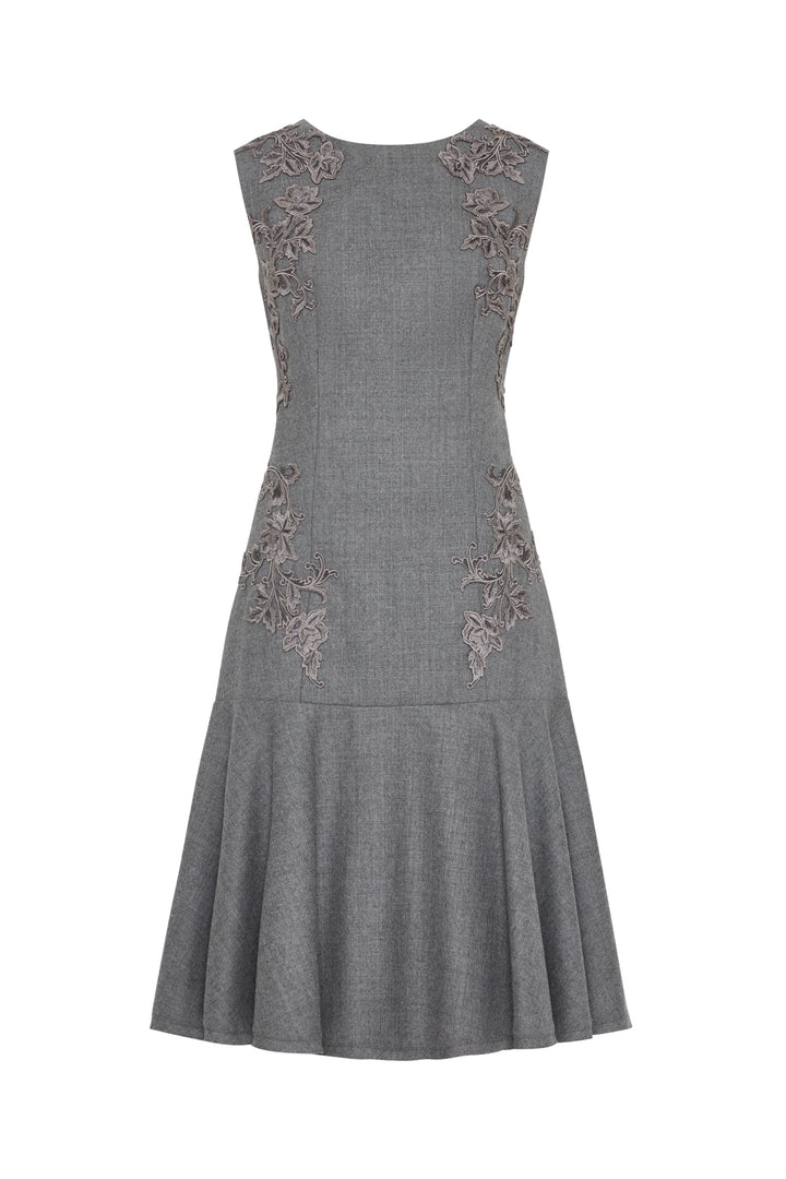Gray flannel dress with floral embroidered bodice, fitted waist, flared knee-length skirt; front view on white.