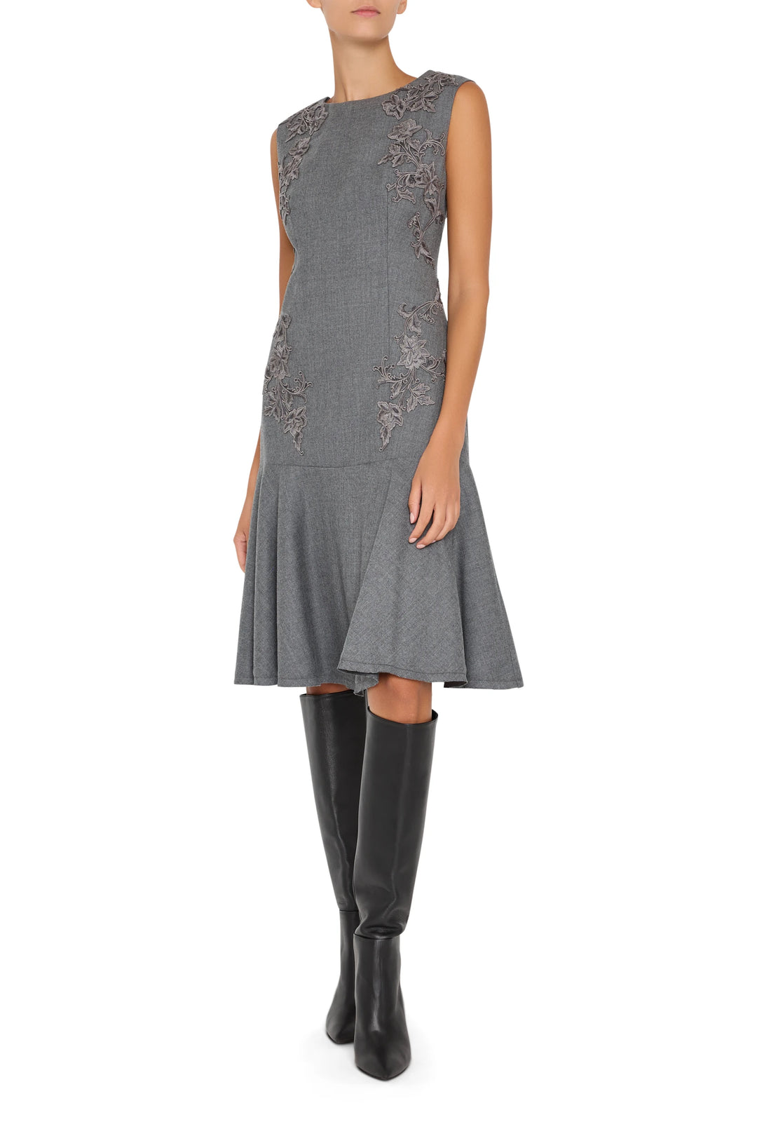 Midi dress with hand embroidery, flannel fabric, fitted bodice, tiered skirt. Front view on white.