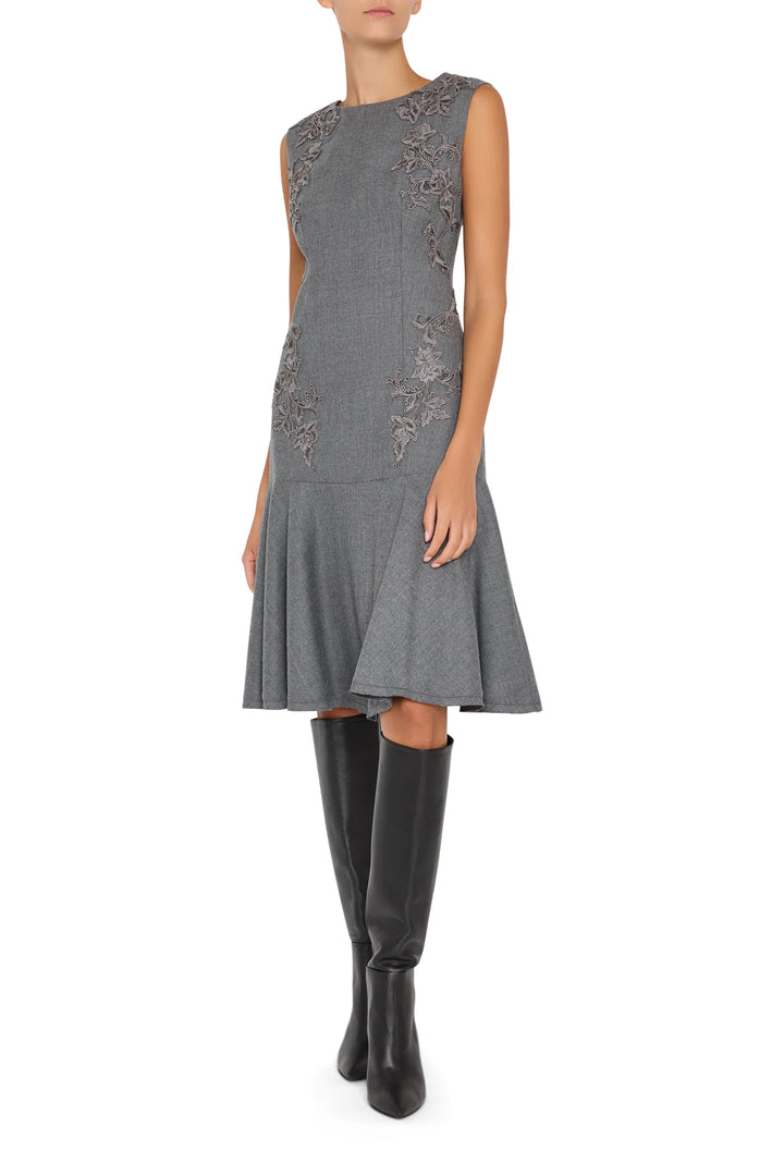 Midi dress with hand embroidery, flannel fabric, fitted bodice, tiered skirt. Front view on white.