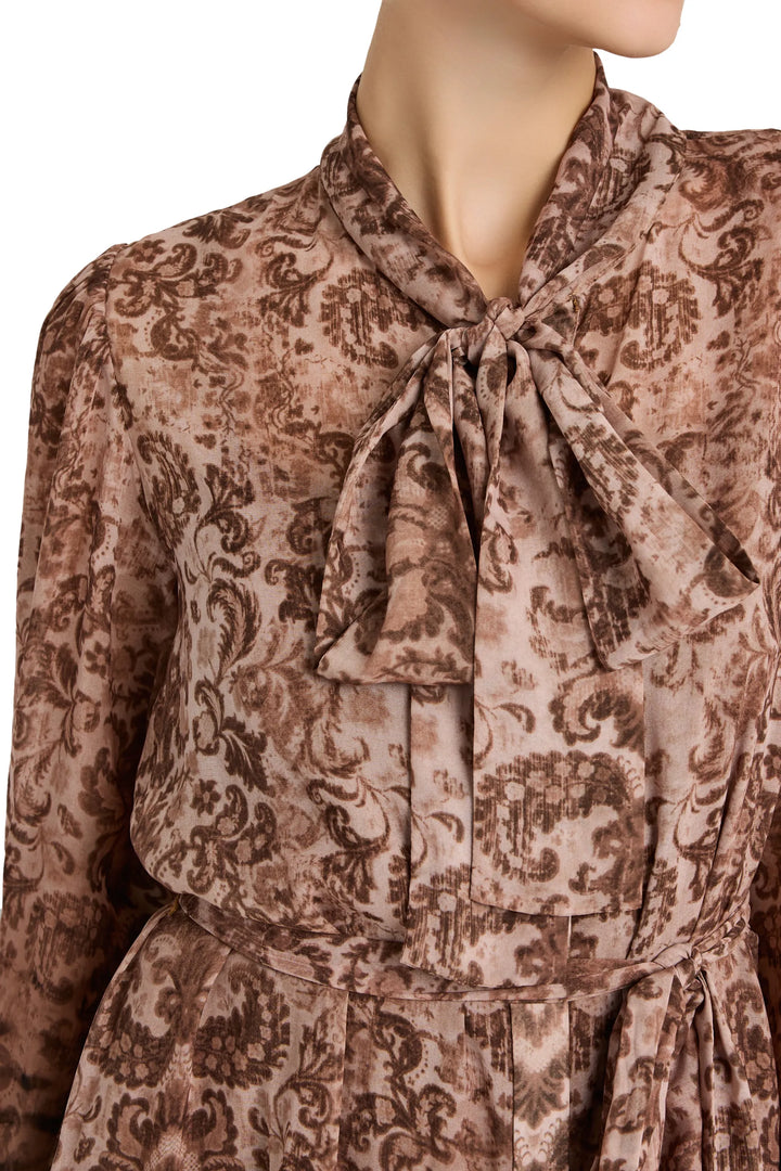 Bow neck, long-sleeve dress with French tapestry print fabric detail; pintucked construction; detail view.