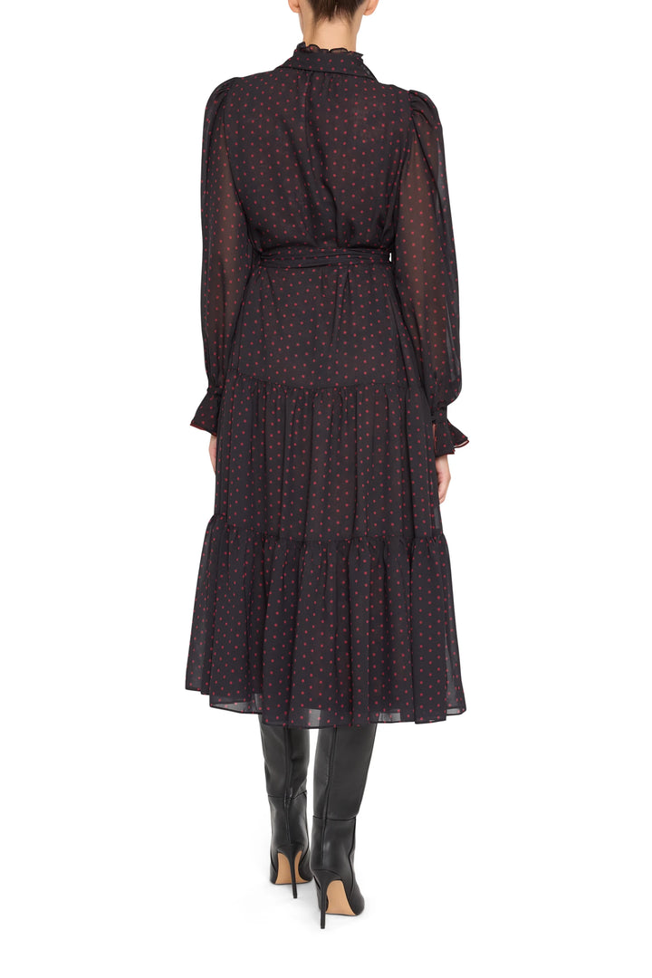 Polka dot chiffon dress with belted waist, midi silhouette, long sleeves. Front view on model.