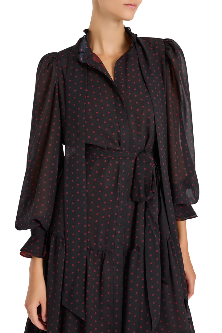 Midi dress with tie neck, belted waist, bishop sleeves in chiffon with polka dots; front view on model.