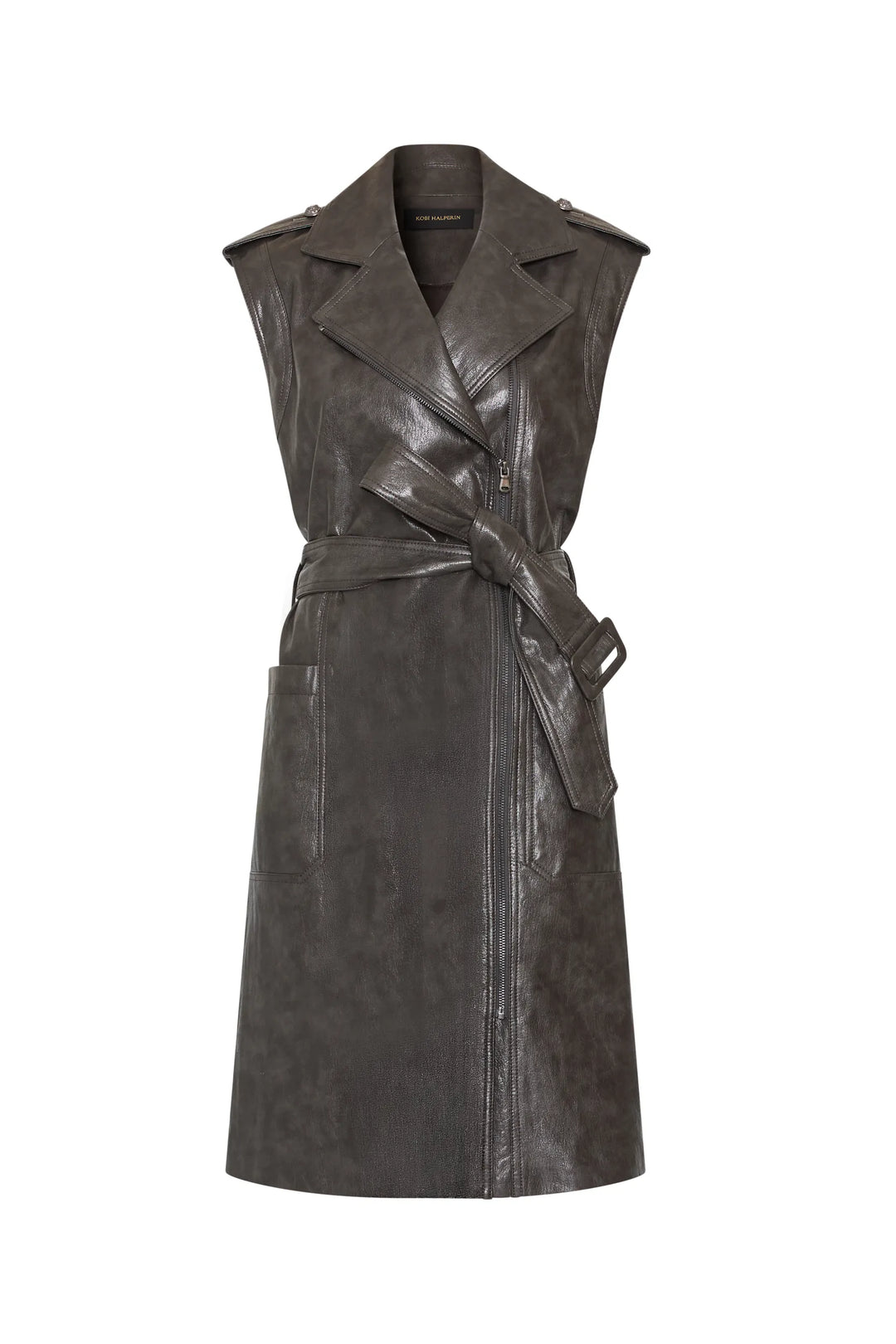 Sleeveless moto-style trench dress in vegan leather with bold lapels, statement belt, side pockets. Front view on white.