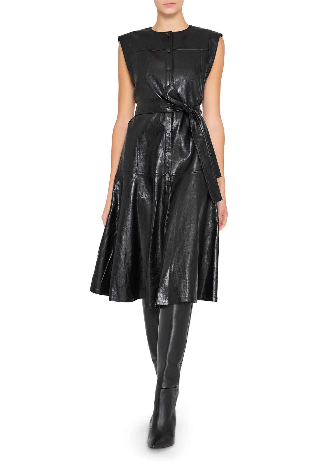 Vegan leather dress with tie belt, structured bodice, long sleeves, knee length; front view on model.