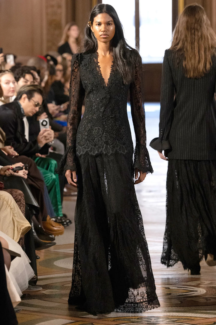 Tori Long Lace Dress: black Chantilly lace midi dress with V-neckline, long sleeves, and flared cuffs, model front view.