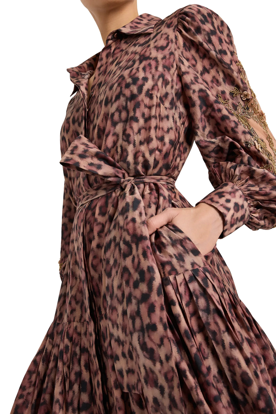 Long-sleeve shirt dress with tied waist belt, collared neckline, curved hem, and straight silhouette; front view on model.