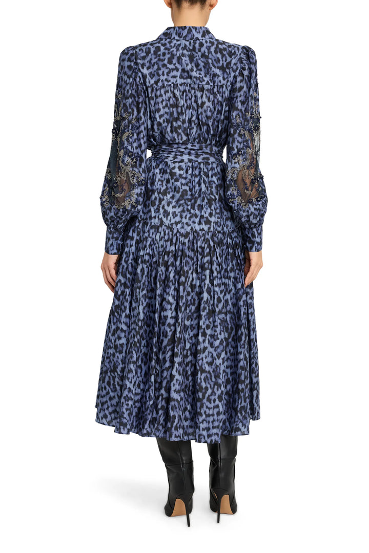 Long-sleeve midi dress with fitted waist, soft drape, and allover print, back view on model.