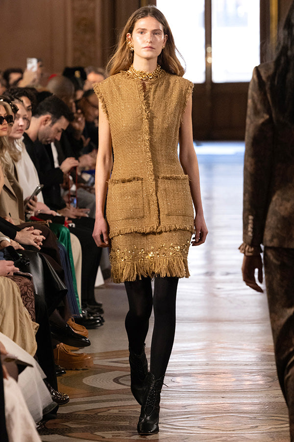 Tweed midi dress with pockets, tailored silhouette, structured seams; front view on model.