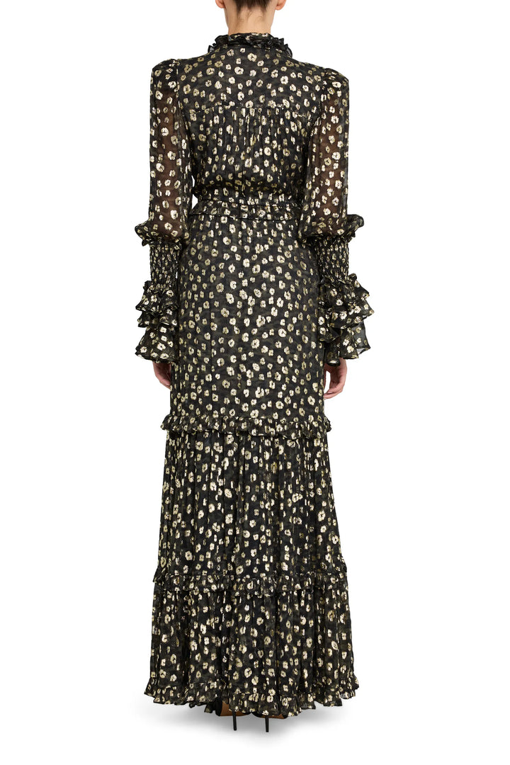 Long, sheer jacquard dress with metallic floral pattern, ruffled sleeves, draped silhouette; back view on model.