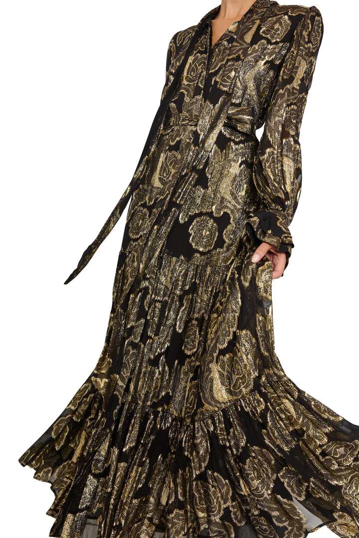 Rian Lurex Jacquard long dress: black and gold metallic floral tiered maxi with tie-neck and bishop sleeves, front view.