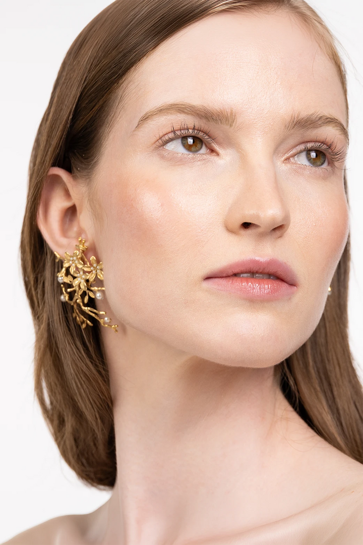 Charlie Earrings, sculptural metal silhouette with minimalist hoop design. Front view on model.