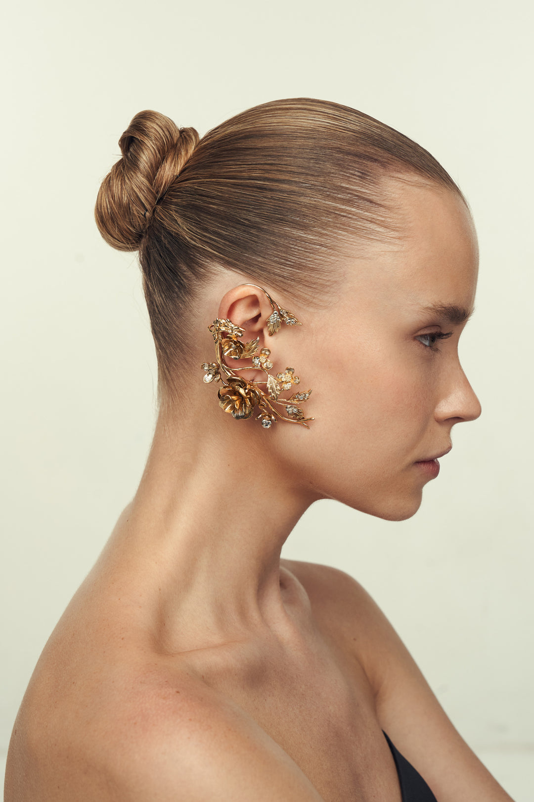 Divida Ear Cuff, sculptural silhouette with layered curves and sleek finish, side view on model.