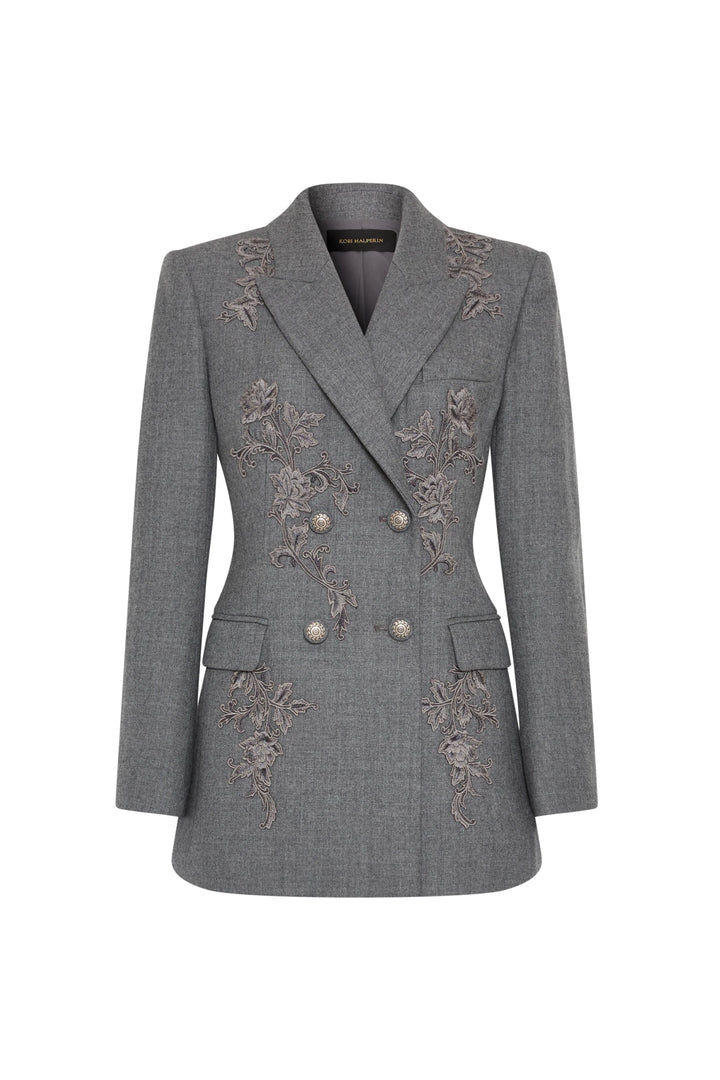 Double-breasted flannel blazer with floral front embroidery, structured silhouette. Front view on white.