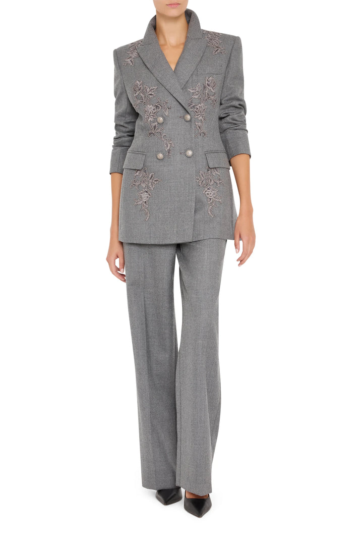 Double-breasted flannel blazer with hand-embroidered floral details, tailored silhouette. Front view on white.