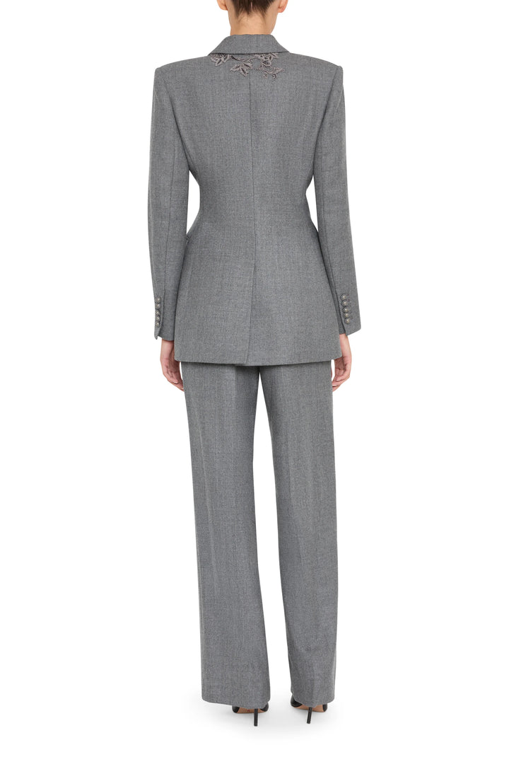 Single-breasted flannel blazer with detailed embroidery, structured shoulders, back vent; back view on model.