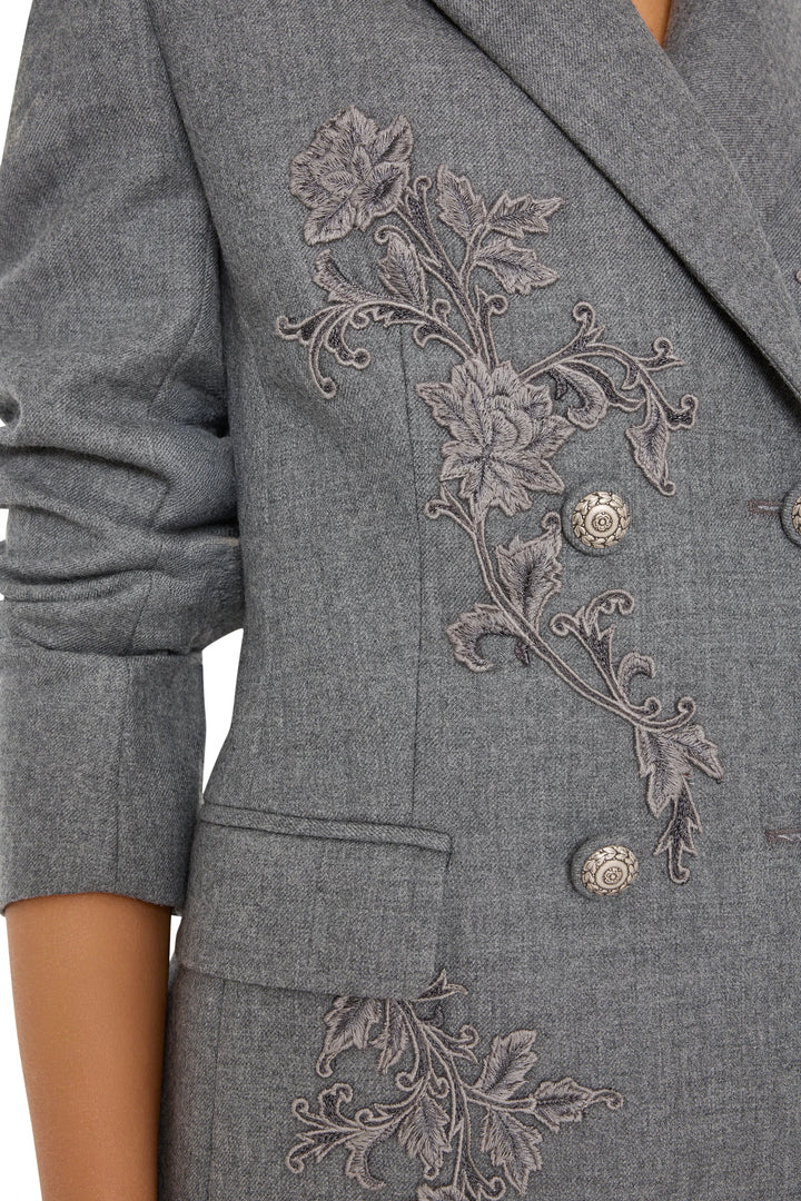 Double-breasted flannel blazer, hand-embroidered floral detail, silver buttons, pocket; front view on white.