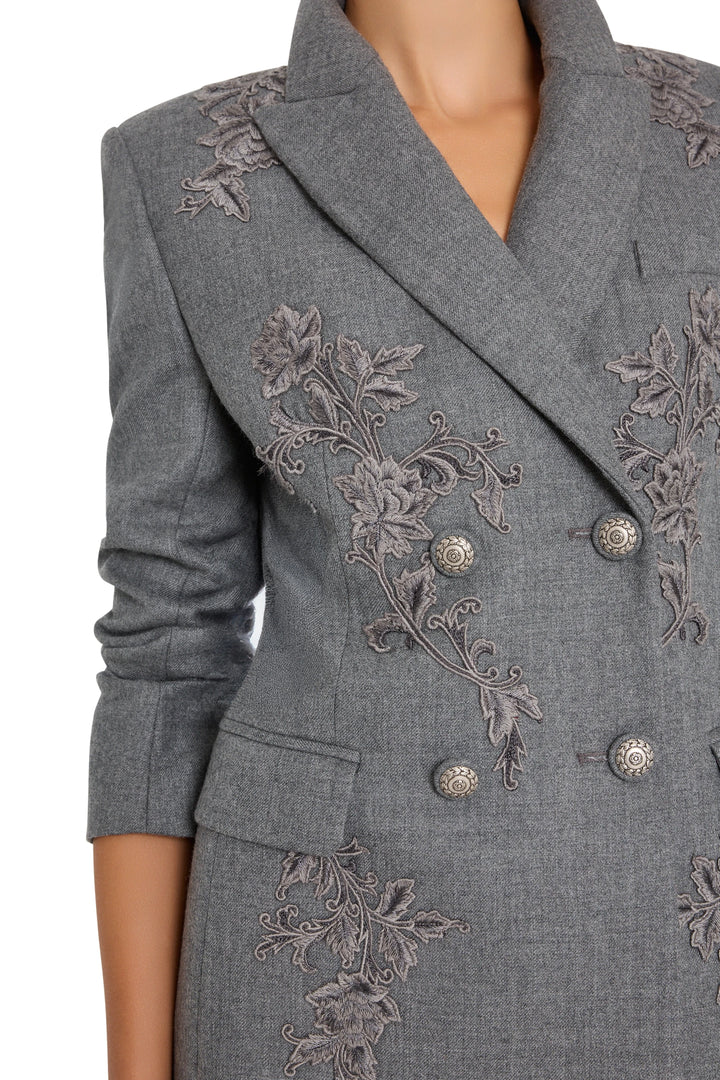 Double-breasted flannel blazer with notched lapels, embroidered accents. Front view on white.