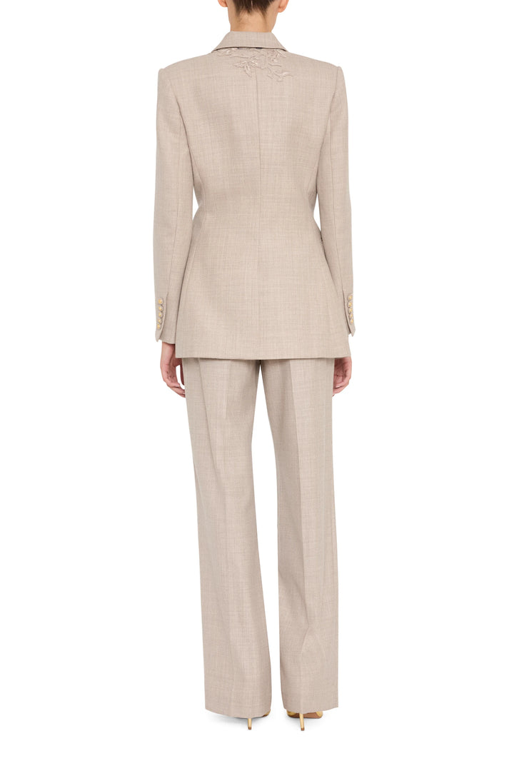 Embroidered flannel blazer with structured silhouette and detailed back stitching; back view on model.