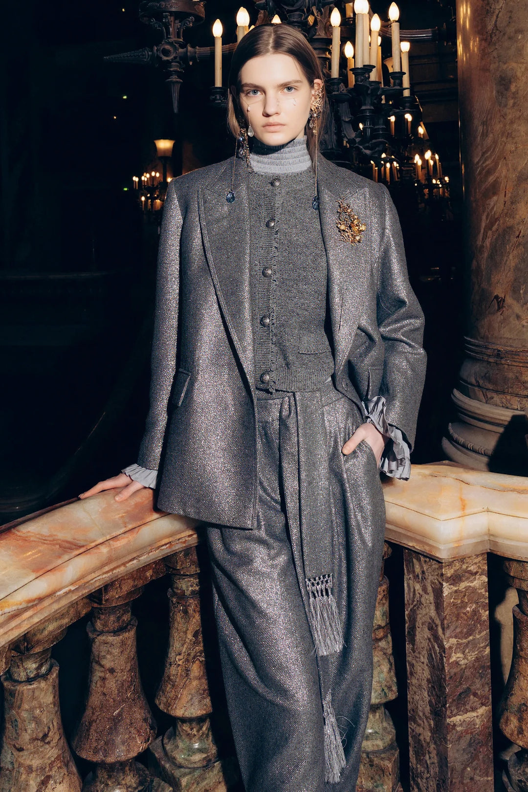 Metallic wool jacket with structured silhouette, single-breasted construction. Editorial setting on model.