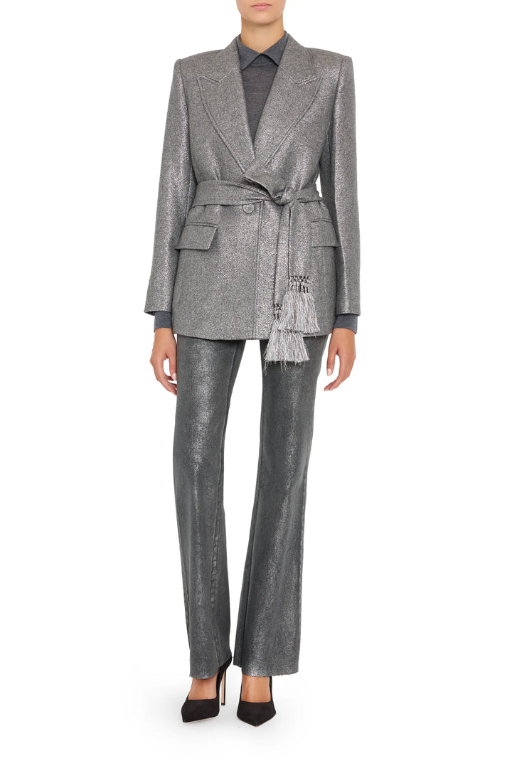Tailored metallic wool jacket with sharp lapels, belted waist, structured shoulders; front view on model.