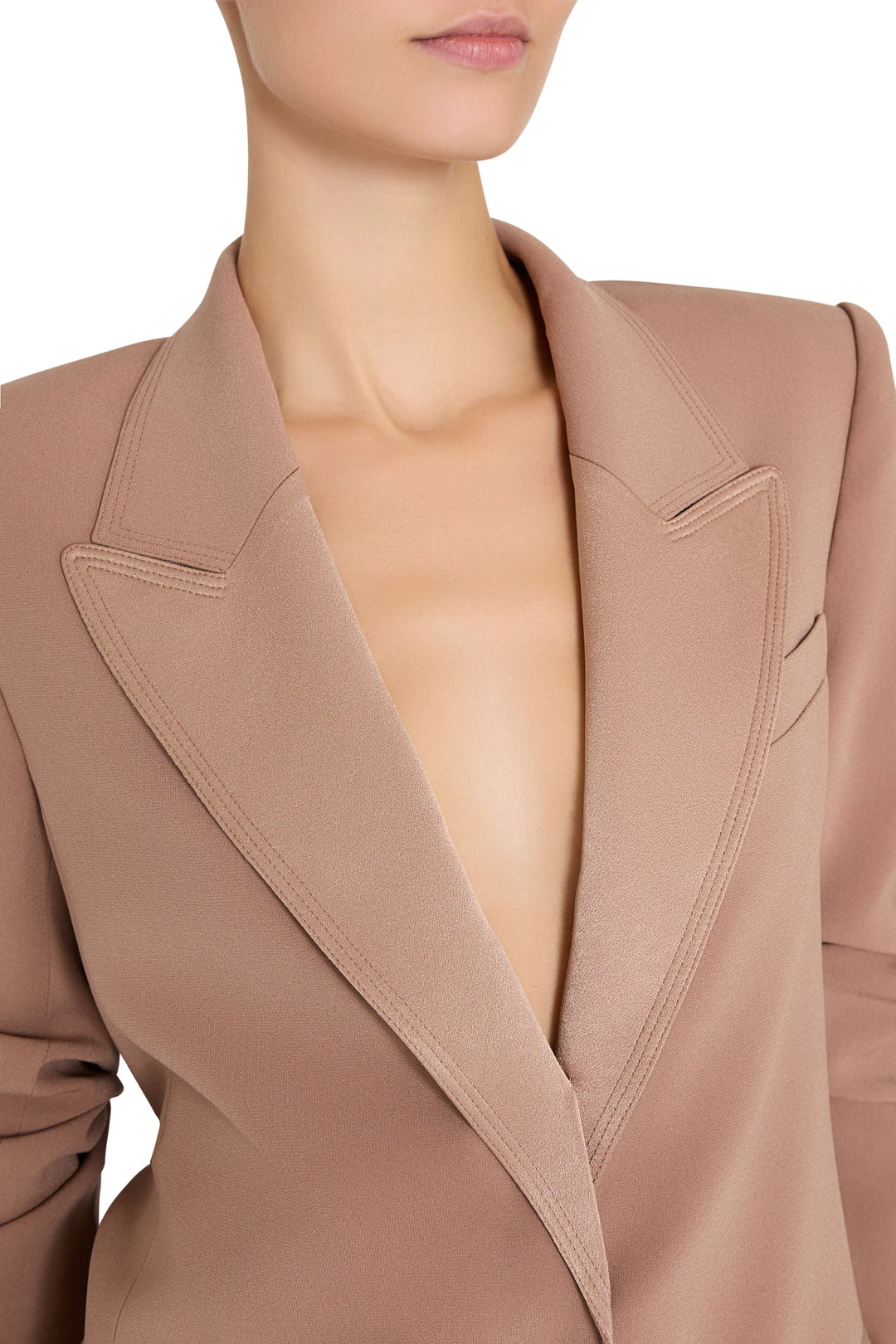 Single-breasted crepe blazer with peak lapels and tailored fit, deep V neckline; front view on model.